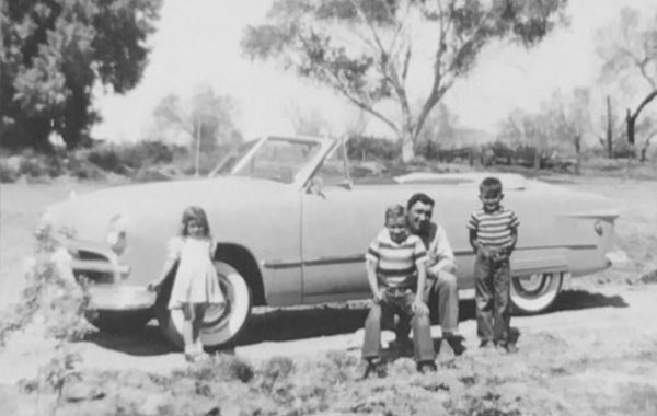 Family posing with Car